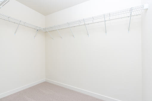 A white wall with a metal rack on it.