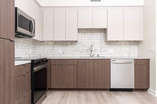 A kitchen with brown cabinets and a black oven.