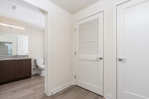 A white bathroom with a toilet and sink.