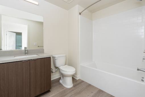 A white toilet sits next to a sink in a bathroom.