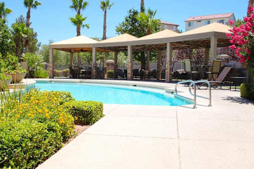 A pool area with a canopy and chairs at Avalon at Seven Hills Apartments, Henderson, 91790