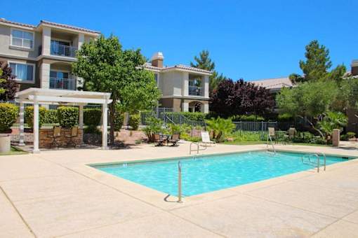 A swimming pool in a residential area with a building in the background at Avalon at Seven Hills Apartments, Nevada, 91790