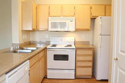 A kitchen with a white stove and white oven at Avalon at Seven Hills Apartments, Henderson, 91790