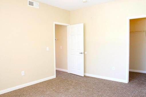 A room with a white door and carpeted floor at Avalon at Seven Hills Apartments, Henderson, NV, 91790