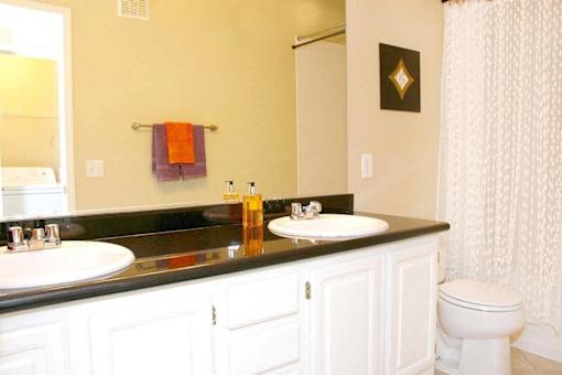 A bathroom with a white toilet and a black counter top at Avalon at Seven Hills Apartments, Nevada, 91790