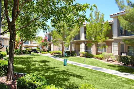 A row of houses with green grass in front at Avalon at Seven Hills Apartments, Henderson, Nevada