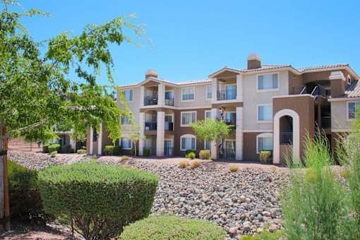 A large building with a balcony on the second floor at Avalon at Seven Hills Apartments, Henderson, 91790