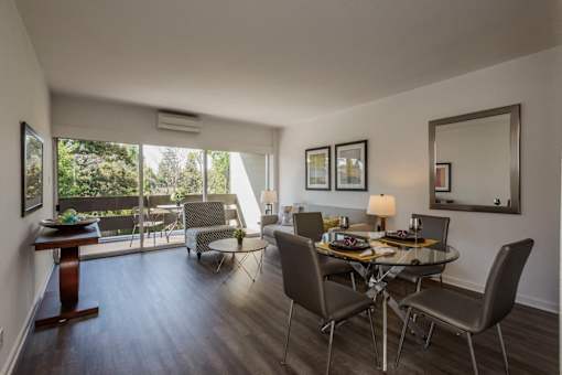 Living and dining room with large windows at Palo Alto Place, California