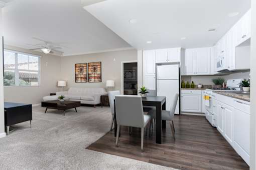 A modern kitchen with a dining table and chairs.