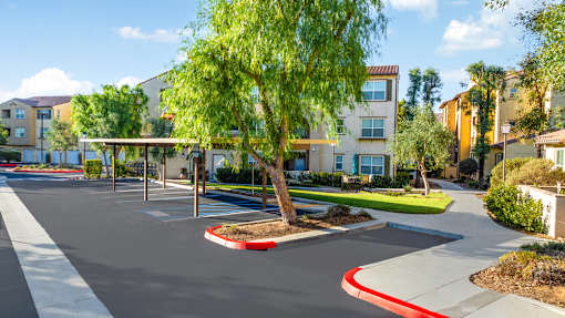 an empty parking lot in front of an apartment building