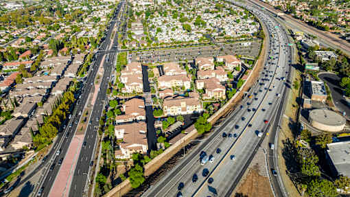 an aerial view of a suburb of a city with highways and cars