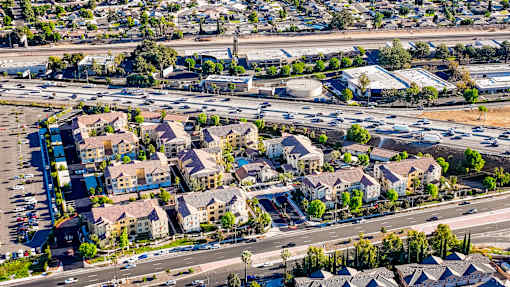 an aerial view of a suburb of a city with an intersection and parking lot