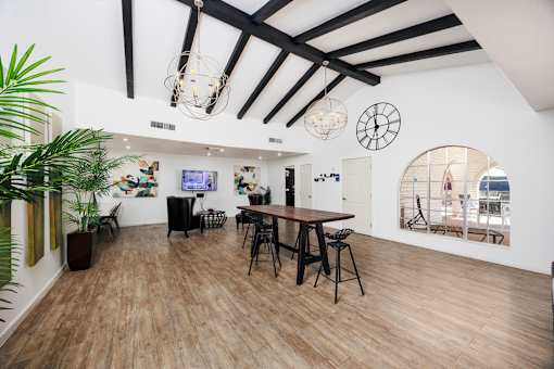 A room with wooden floors and a large mirror on the wall.