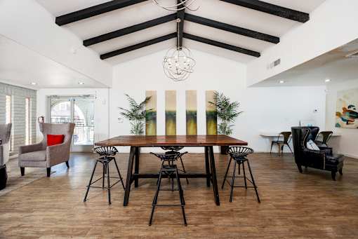 A dining room with a wooden table and chairs.