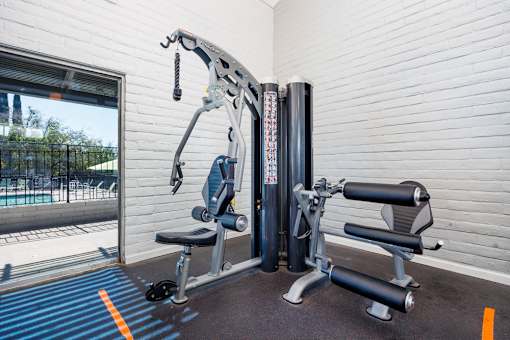 A gym machine is in front of a window.