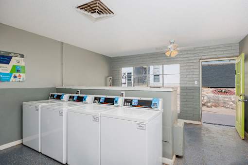 A laundry room with washers and dryers.