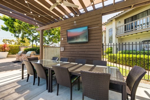 Outdoor dining area and TV adjacent to grill at Pointe Niguel, Laguna Niguel, California