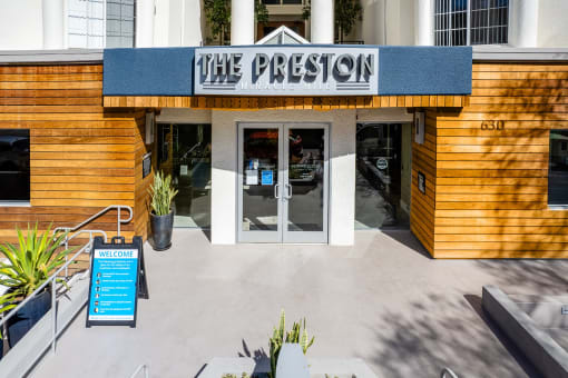 Community exterior with signage at The Preston Miracle Mile Apartments, Los Angeles, 90036
