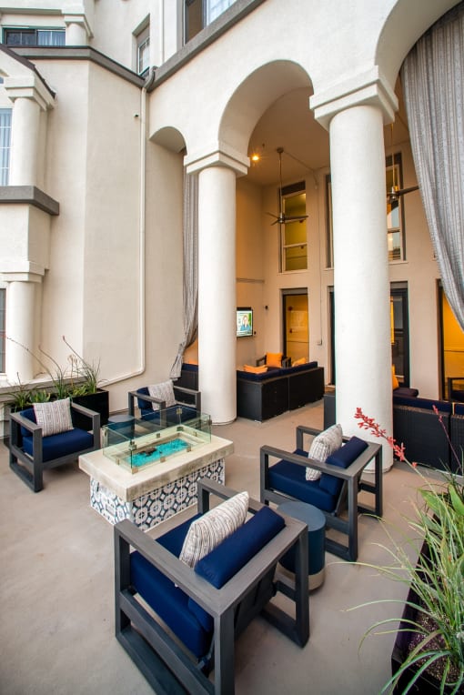 Dog-Friendly Apartments in Los Angeles, CA - The Preston - Outdoor Lounge with Patio Furniture, Firepit, and Tall Pillars.