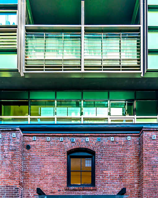 A red brick building with a window and a balcony above it.at Arc Light, San Francisco, CA 94107