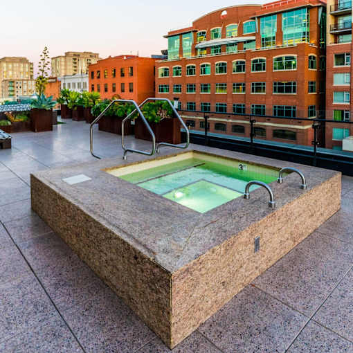 A hot tub on a rooftop patio surrounded by buildings.at Arc Light, San Francisco, CA