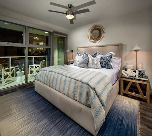 A bedroom with a large bed and a ceiling fan.at Chelsea Santa Monica, California  