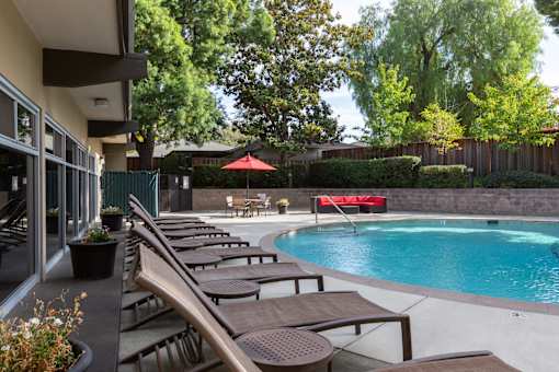 Swimming Pool Area With Shaded Chairs at Palo Alto Place, California