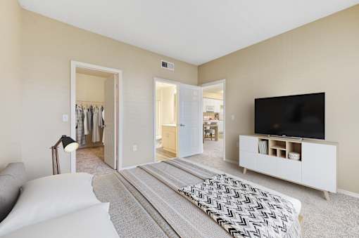 A living room with a television and a large bed.