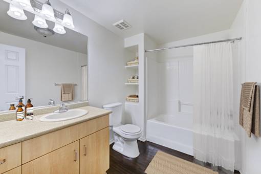 A bathroom with a toilet, sink, and shower.