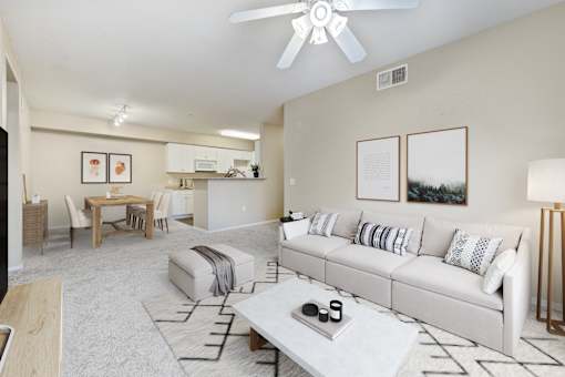 A living room with a white couch and a coffee table.
