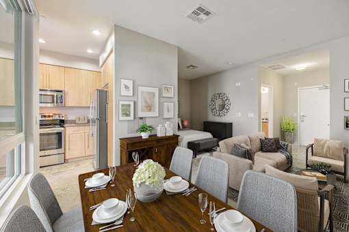 Pet-Friendly Apartments in Long Beach, CA - Urban Village - Dining Area With Wood Table, Upholstered Chairs, Large Window, And Open Views Into The Kitchen And Living Space.