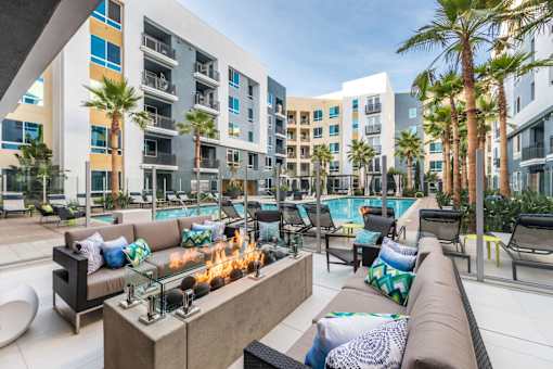 A modern outdoor seating area with a fire pit at Rize Irvine, California