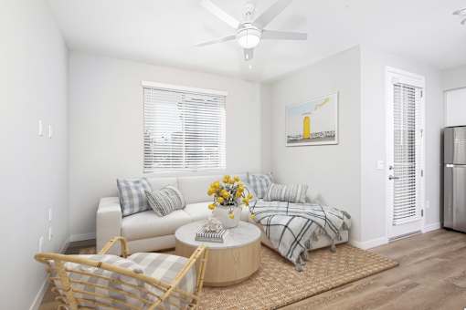 A living room with a sofa, a coffee table, and a painting on the wall.