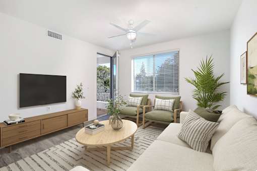 A living room with a flat screen TV, a coffee table, and a couch.