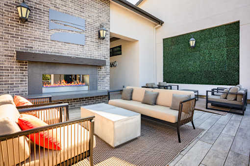A patio with a fireplace and seating area.