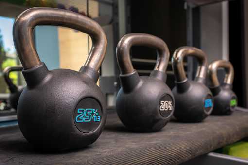 A set of kettlebells with the numbers 25, 20, and 15 written on them.