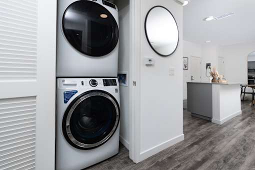 A modern laundry room with a washing machine and a dryer.