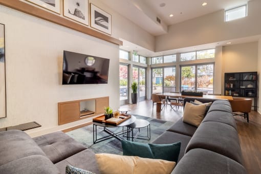 a living room with a large gray couch and a fireplace at Strata at Mission Bay, California