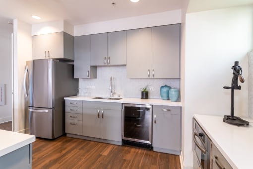 a renovated kitchen with stainless steel appliances and white cabinets at Strata at Mission Bay, San Francisco, CA