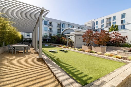 a backyard with a lawn and a table and chairs at Strata at Mission Bay, San Francisco, California