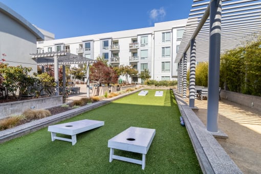 Outdoor Recreation Area with Artificial Turf, Corn Hole Boards, Landscaped Plants, Gravel, Seating Area  at Strata at Mission Bay, San Francisco