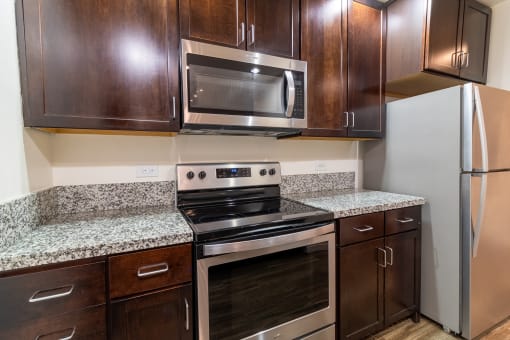 a kitchen with wood cabinets and stainless steel appliances and granite counter tops