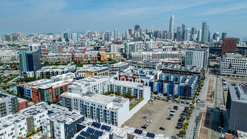 A cityscape with a mix of residential and commercial buildings.