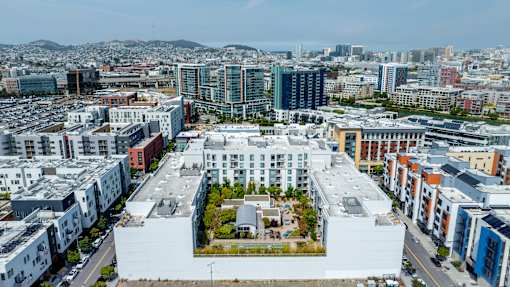 A large white building with a courtyard in the middle of a city.