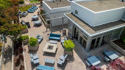 A patio area with tables and chairs is shown from an aerial perspective.
