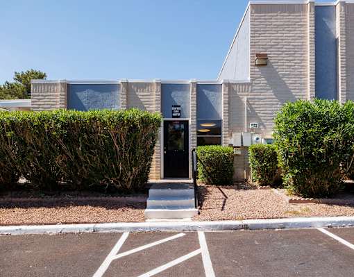 A building with a black door and a sign that says "E" on it.