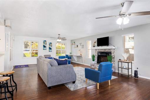 A living room with a grey couch and a blue armchair.