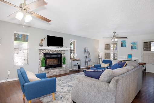 A living room with a fireplace, a couch, and a television.