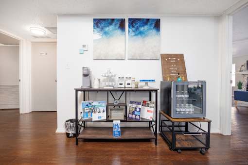 A room with a table and a display of items for sale.