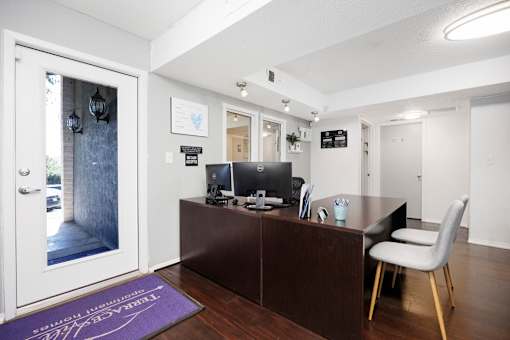 A reception area with a desk and a chair.